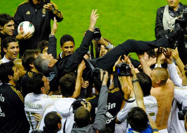 Real Madrid's coach Jose Mourinho is thrown in the air by his players after their win over Athletic Bilbao to win the Spanish first division league title in Bilbao